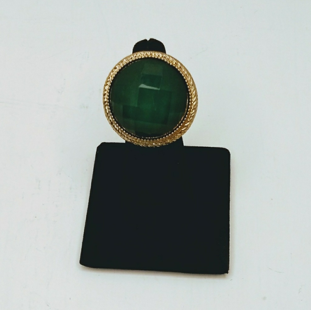 Gold tone with green lucite stretch to fit ring